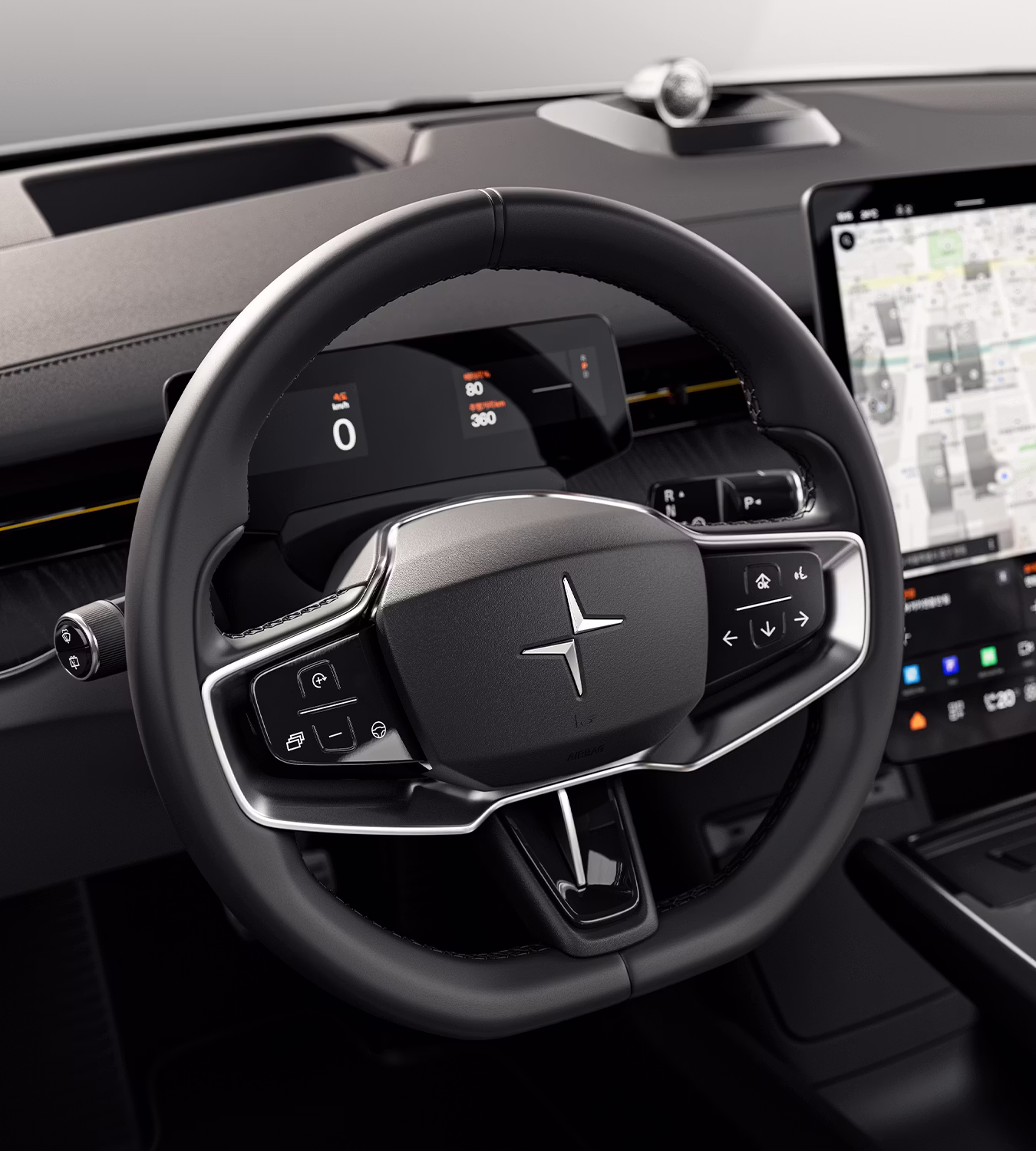 Polestar 3’s steering wheel with silver accents and Polestar logo in front of the driver display.