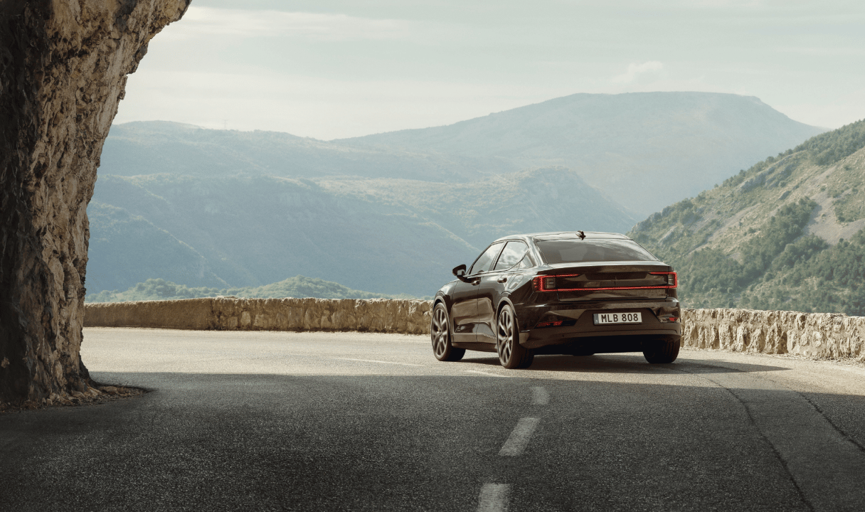 Polestar 2 on a mountain road overlooking a valley