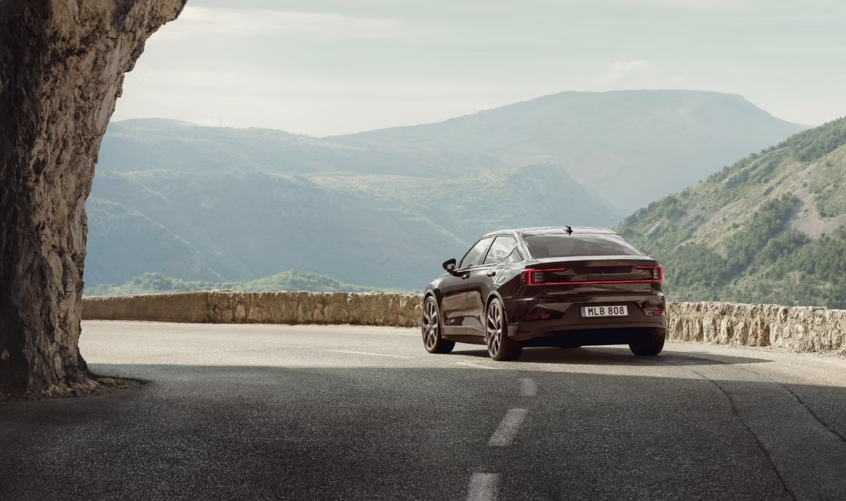 Polestar 2 on a mountain road overlooking a valley