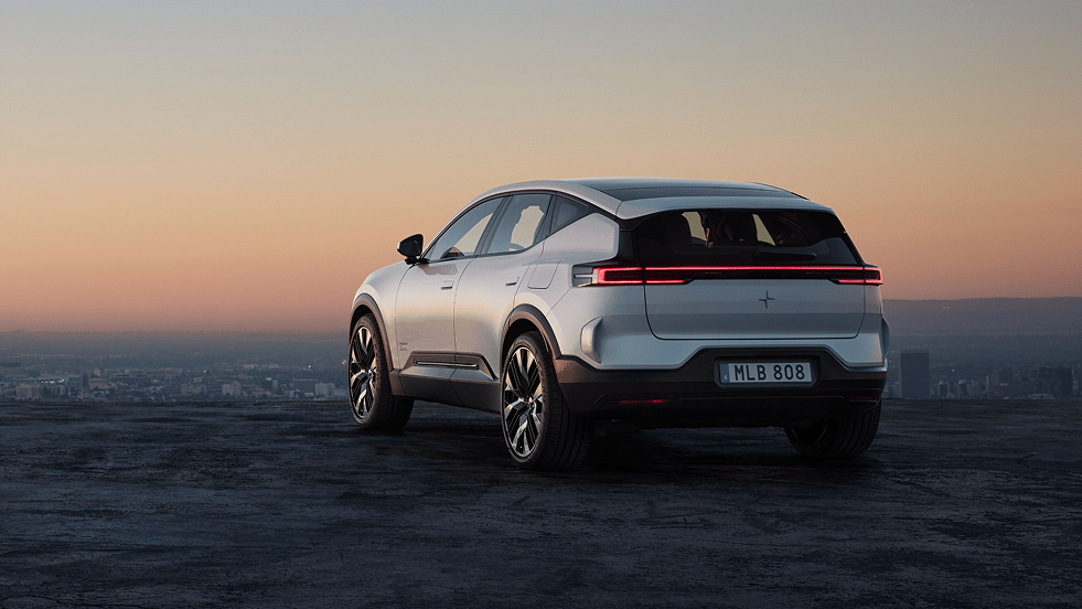 Polestar 3 SUV viewed from the rear on a hilltop at sunset