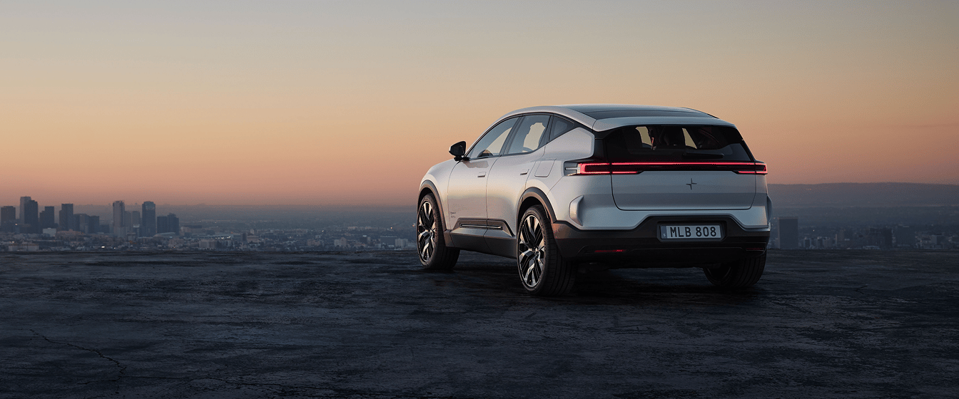Polestar 3 SUV viewed from the rear on a hilltop at sunset