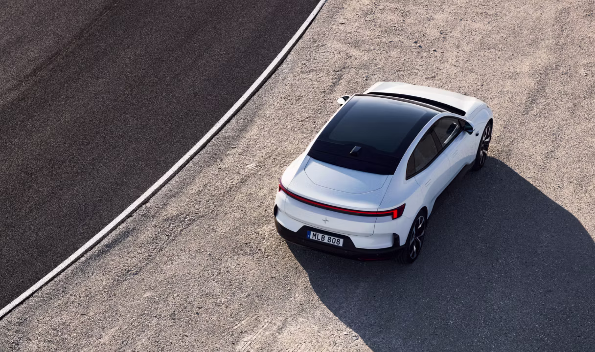 Polestar 4 Coupé parked on gravel beside a road