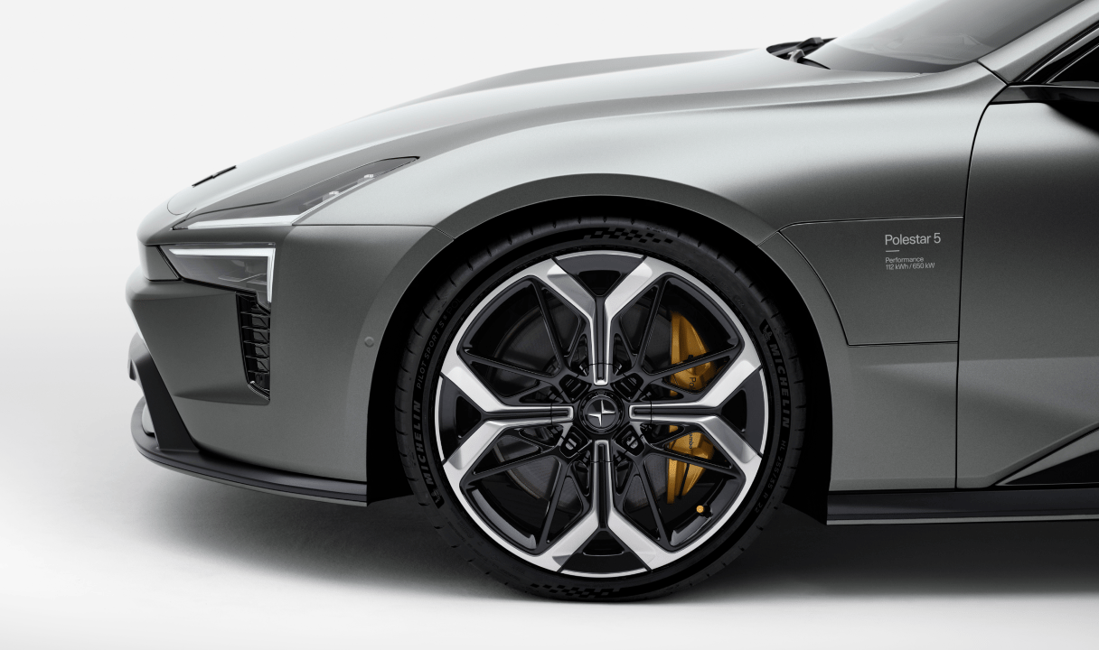 Front side of a Polestar 5 with wheel and headlight visible
