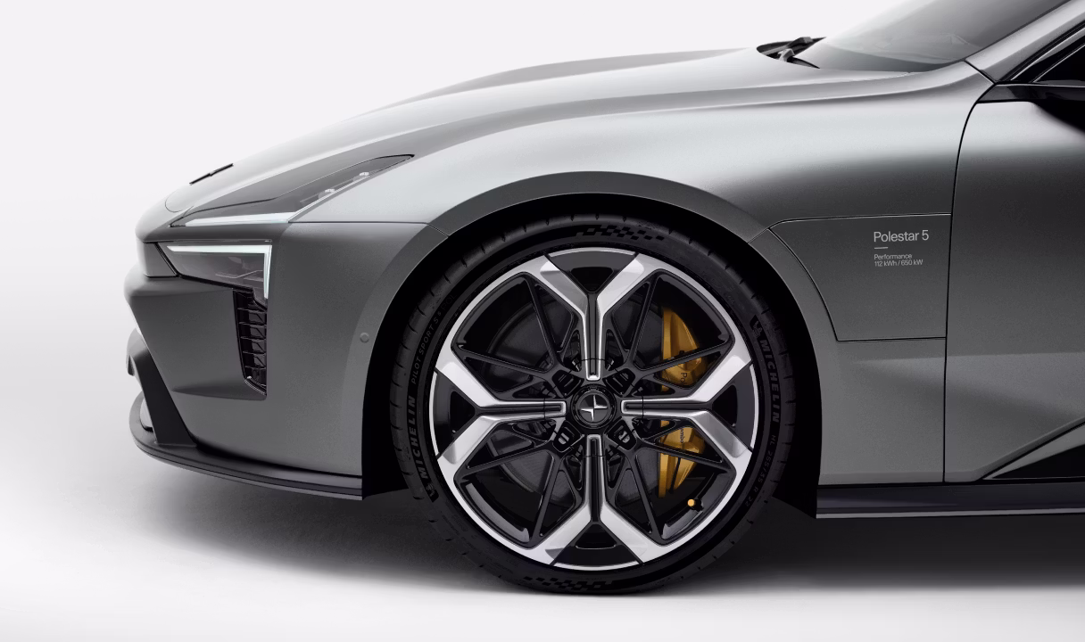 Front side of a Polestar 5 with wheel and headlight visible
