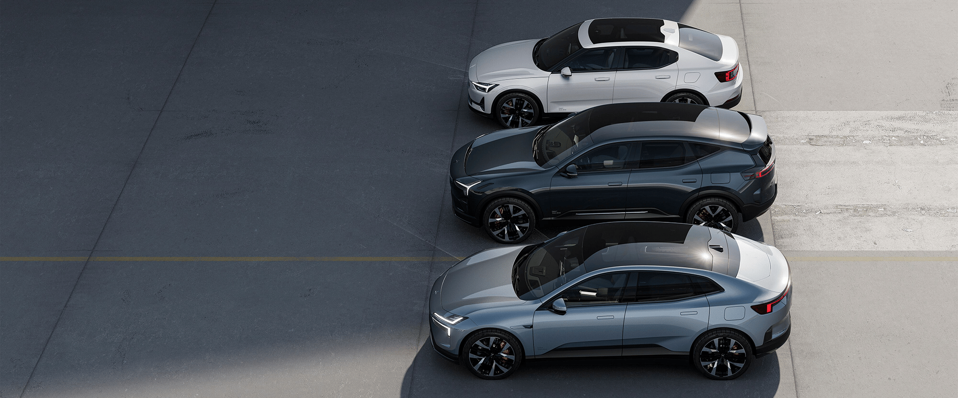Three Polestar cars parked side by side on a paved surface, viewed from above