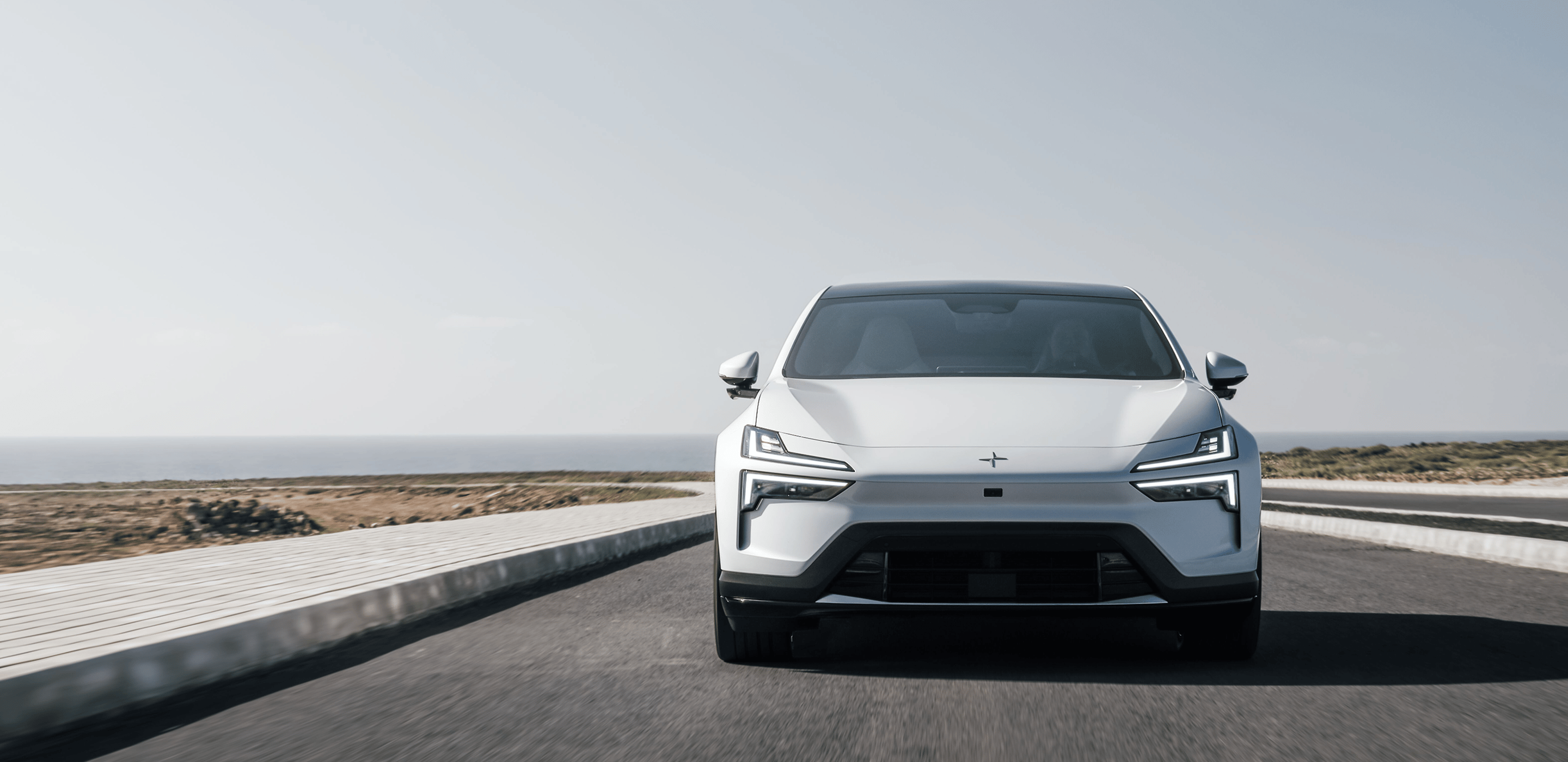 Polestar 4 Coupé driving on a coastal road