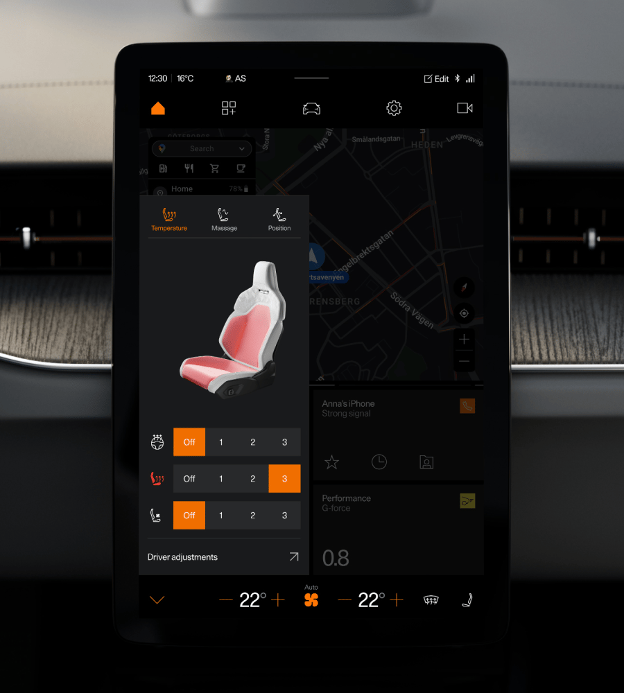 Car touchscreen showing seat temperature and massage controls over a map