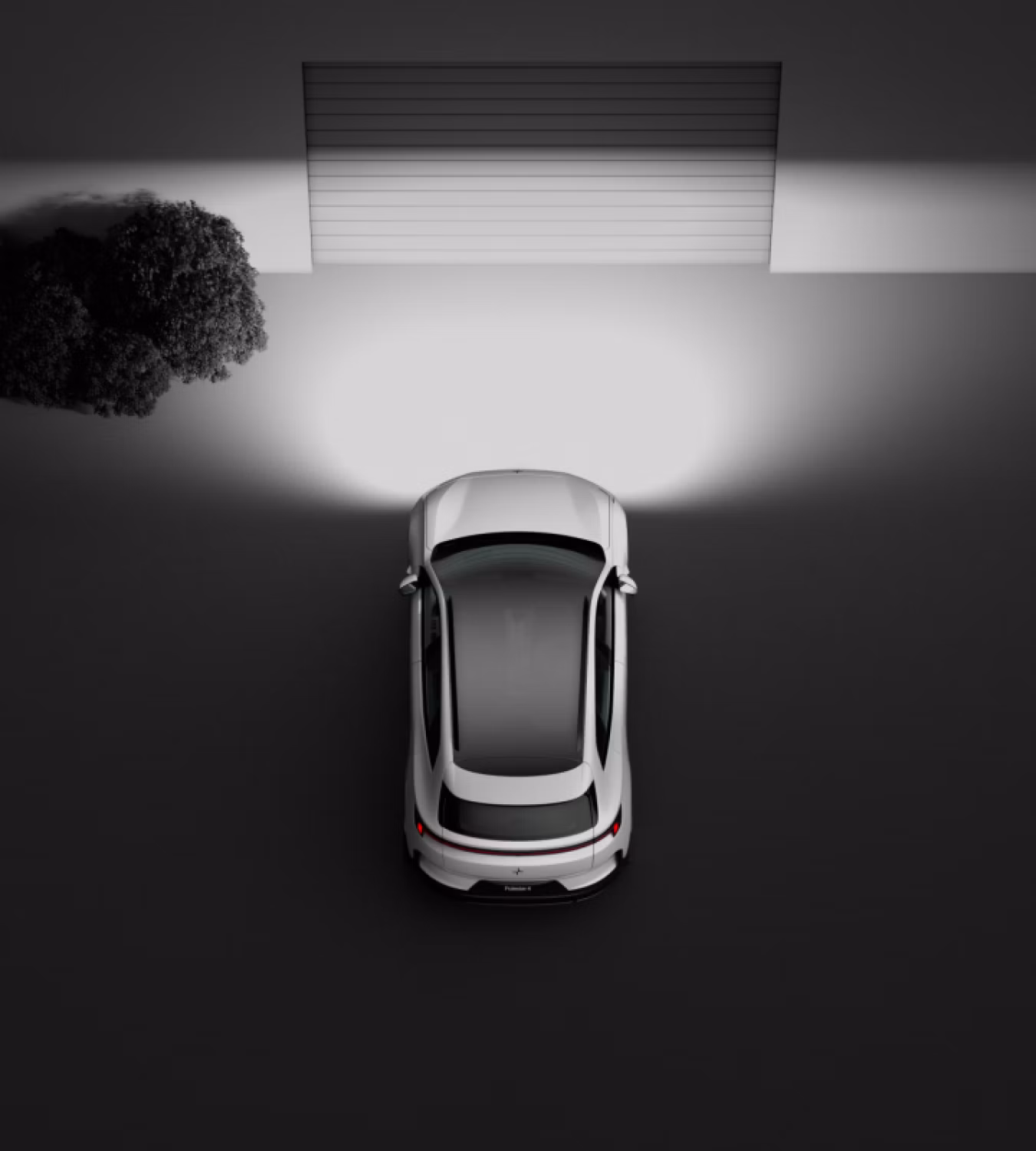 Polestar 4 SUV shining its headlights onto a closed garage door.