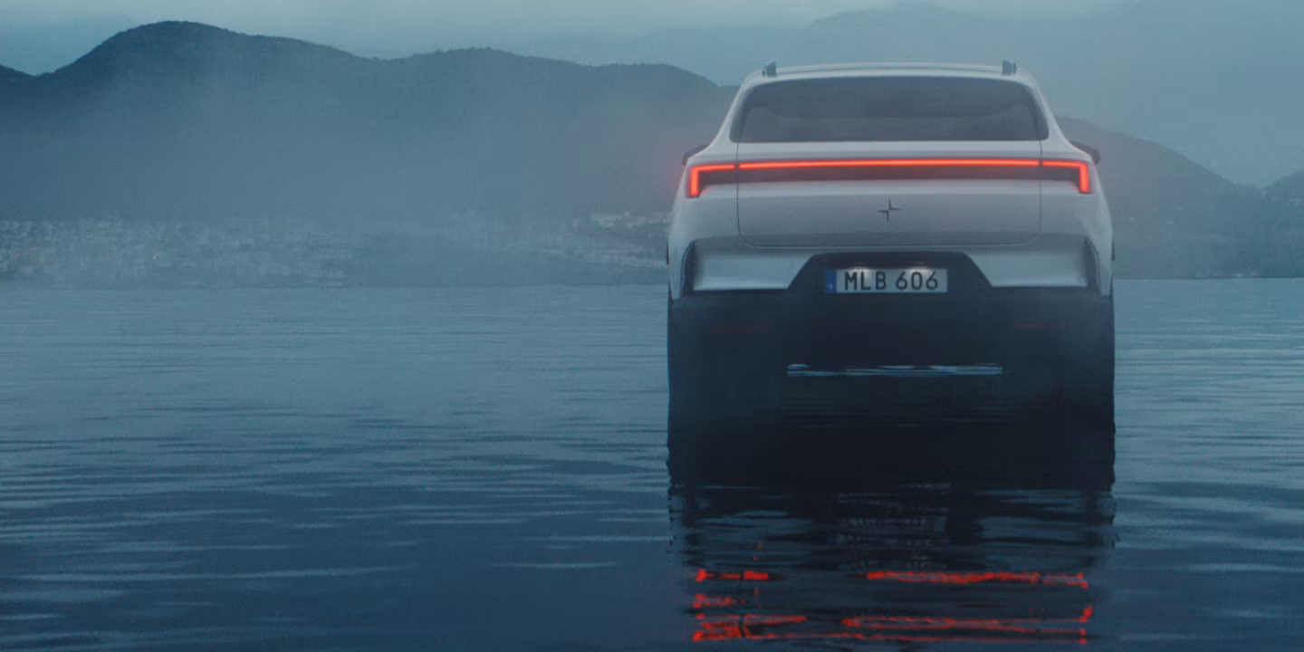 Polestar 4 SUV viewed from the rear on water with taillights on