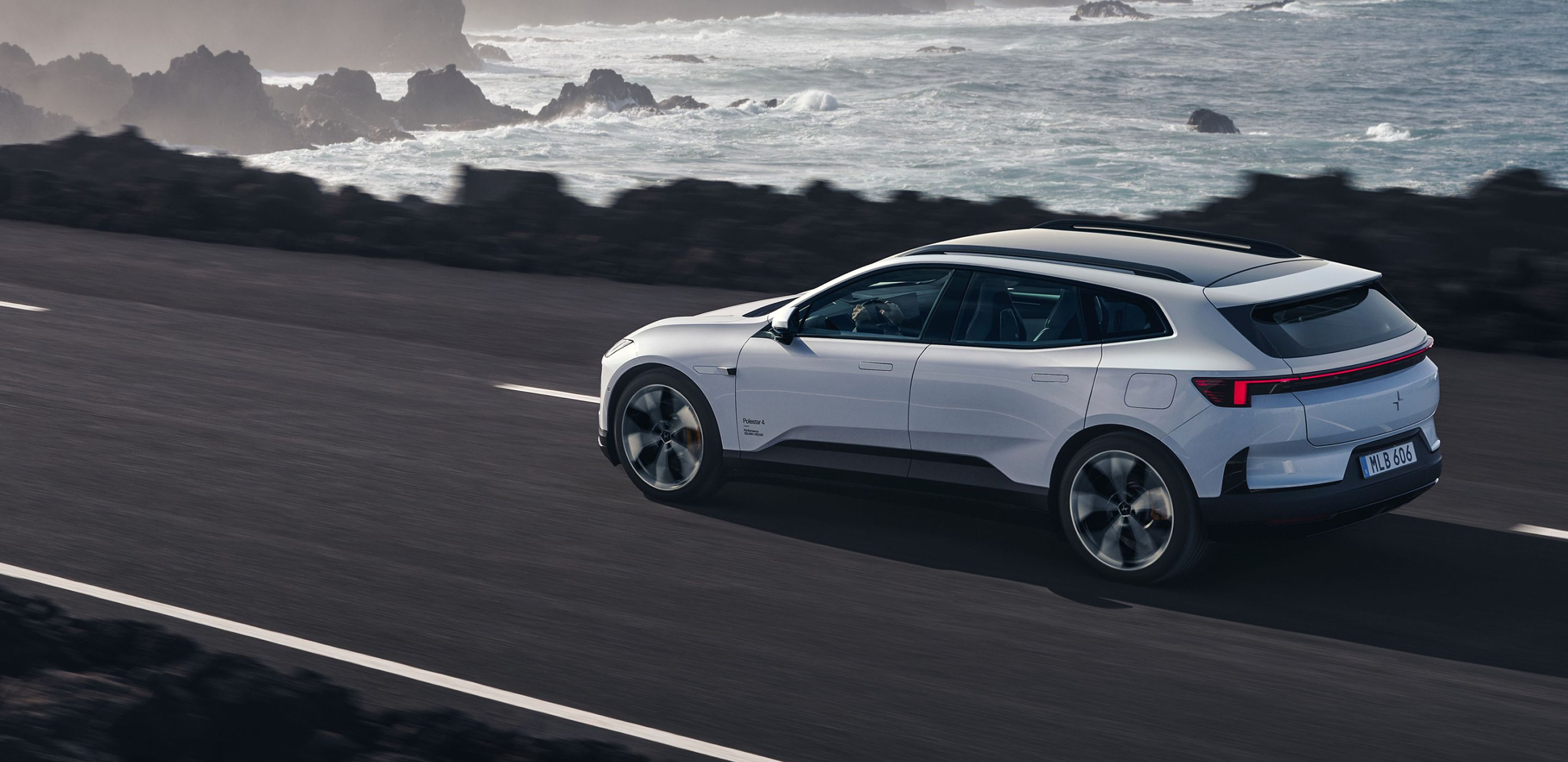 Polestar 4 SUV driving on a coastal road