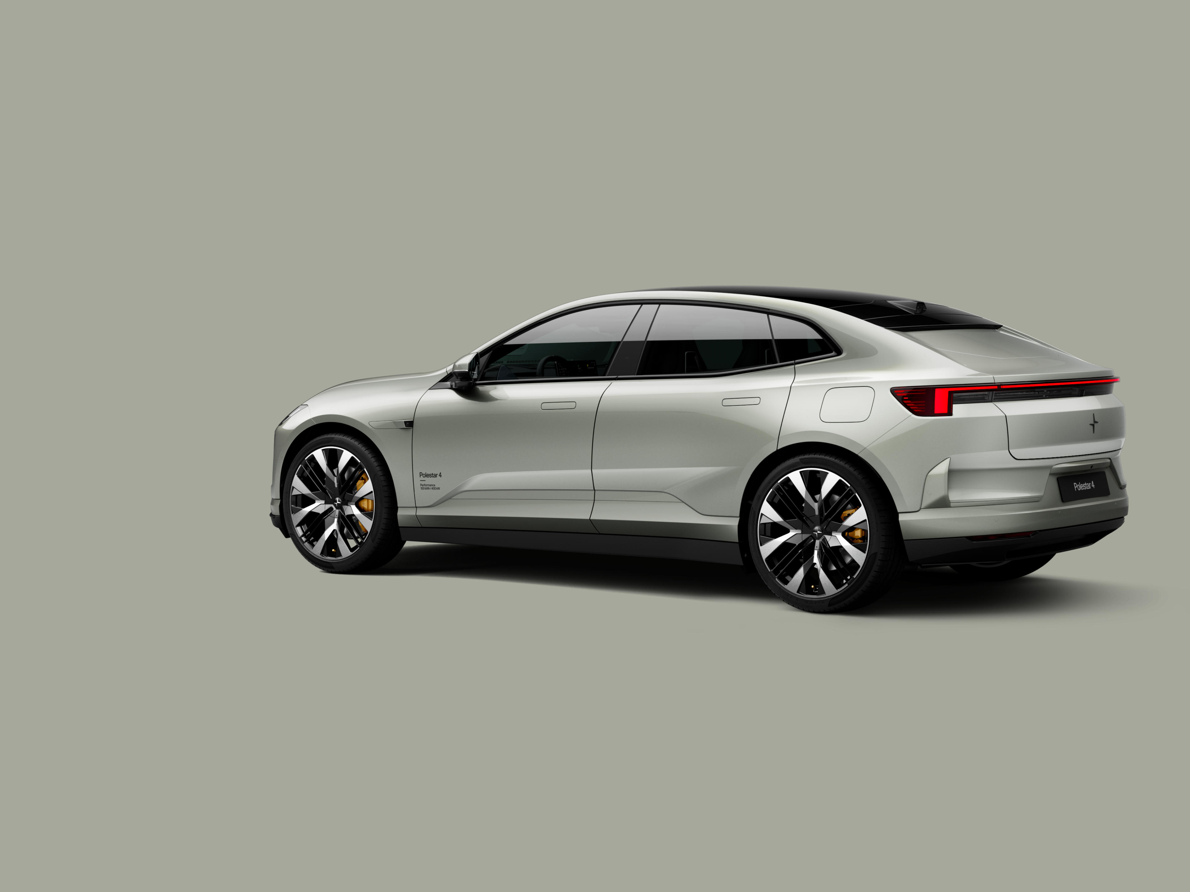 Polestar 4 coupé shown from the rear side on a plain background