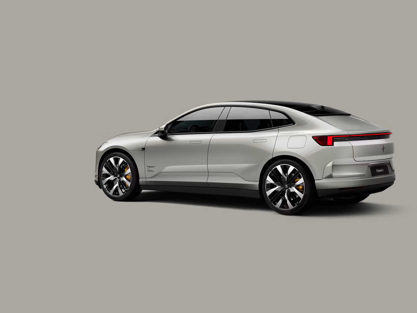 Polestar 4 coupé shown from the rear side on a plain background