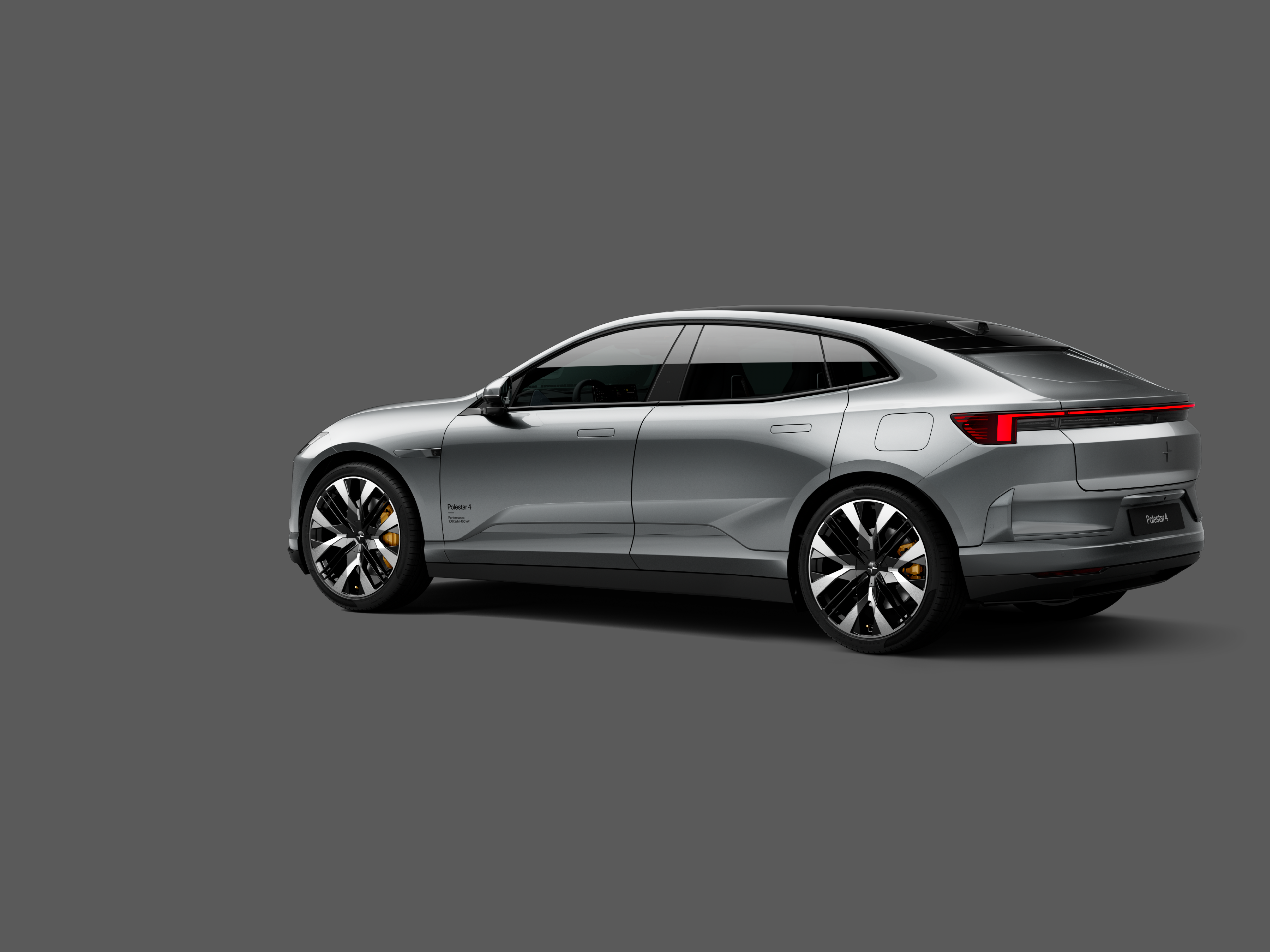 Polestar 4 coupé shown from the rear side on a plain gray background