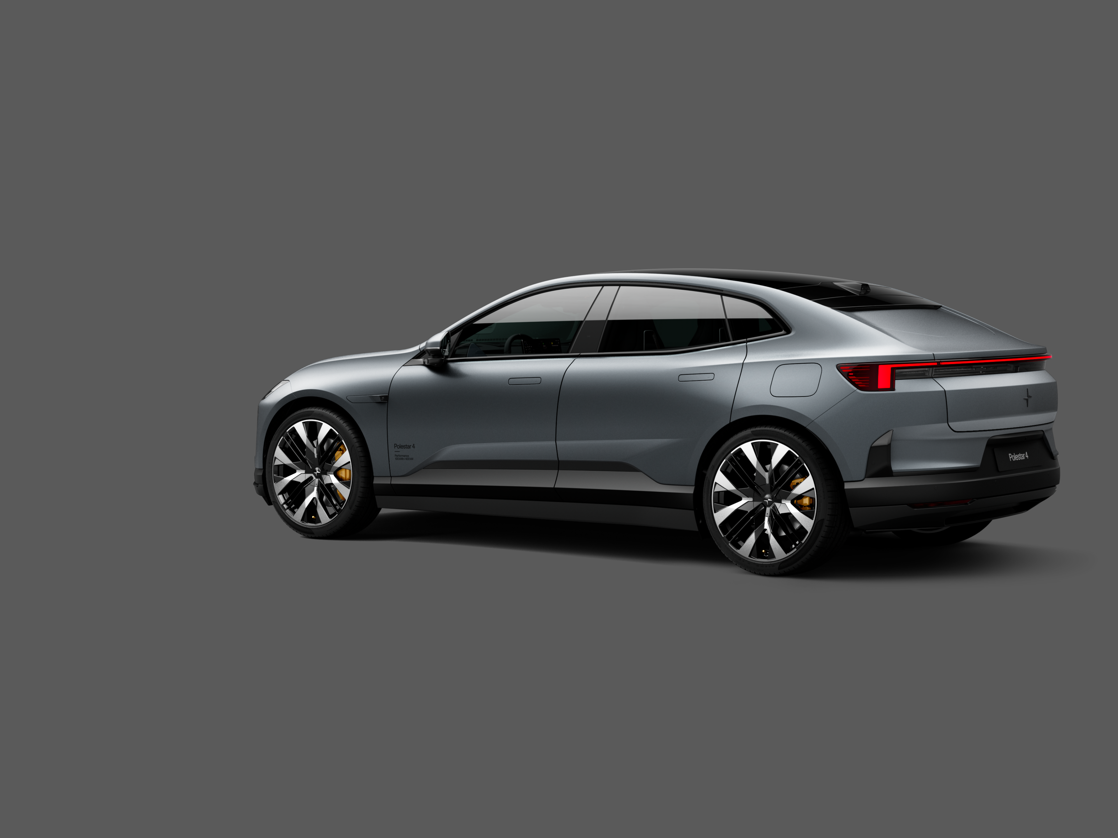 Polestar 4 coupé shown from the rear side on a plain gray background