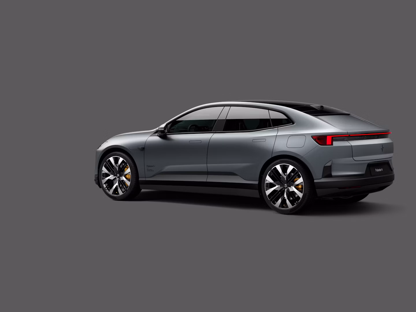 Polestar 4 coupé shown from the rear side on a plain gray background